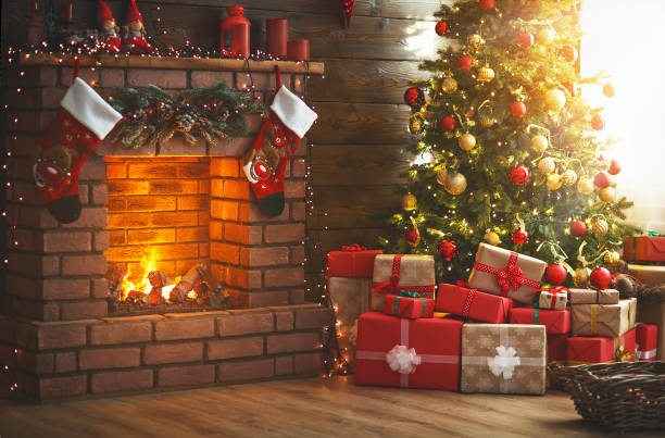 interior christmas. magic glowing tree, fireplace and gifts